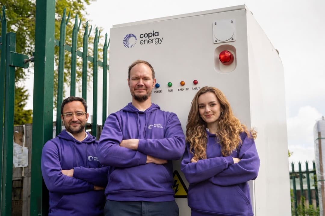 Annamaria with Copia Energy colleagues beside energy equipment