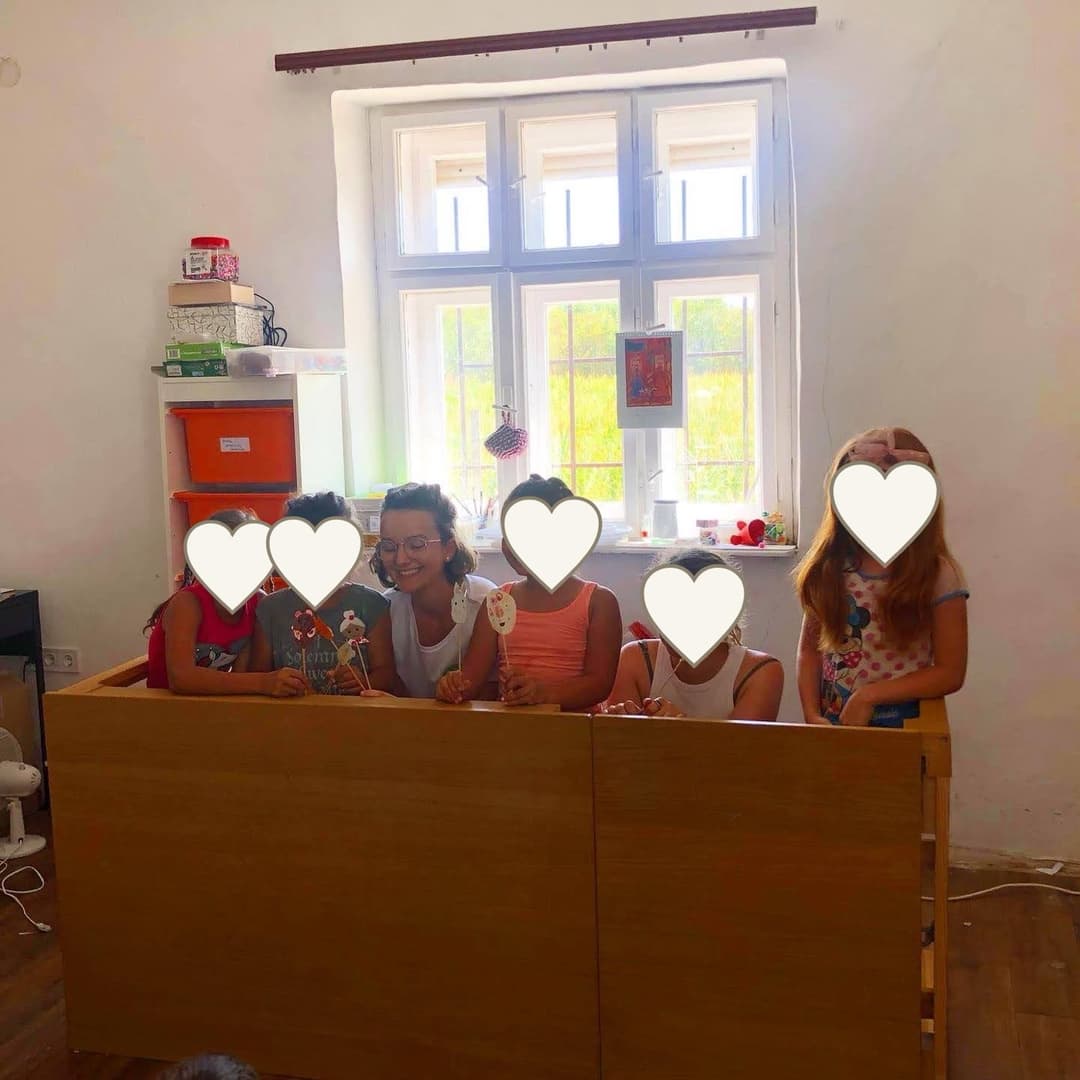 Classroom volunteer activity with children’s faces covered for privacy