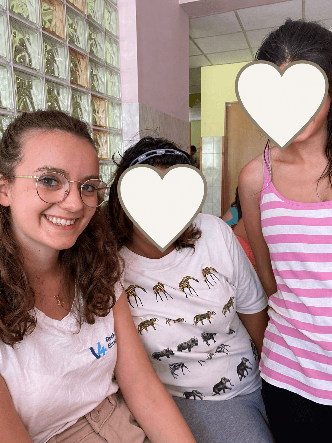 Volunteer selfie with children’s faces covered for privacy